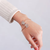 Close-up of the intricate leaf details on the gold bracelet